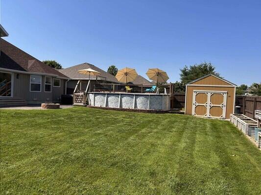 201 Sparrow Ln, Willard, MO 65781 - fenced backyard featuring a storage shed