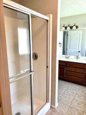201 Sparrow Ln, Willard, MO 65781 - full bathroom with double vanity, a stall shower, and tile patterned flooring