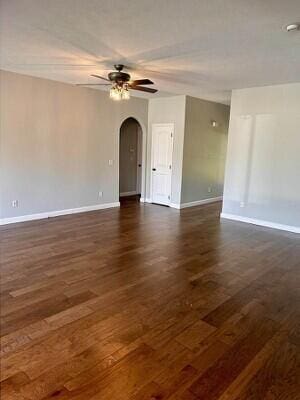 201 Sparrow Ln, Willard, MO 65781 - spare room with arched walkways, ceiling fan, dark wood finished floors, and a smoke detector