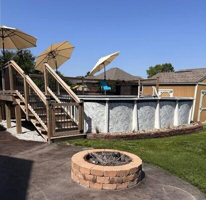201 Sparrow Ln, Willard, MO 65781 - view of patio / terrace with stairs, a fire pit, an outdoor pool, and a storage shed