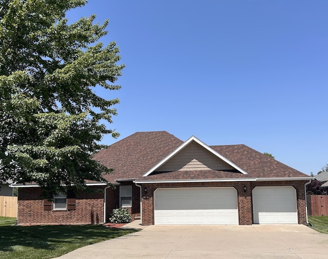 201 Sparrow Ln, Willard, MO 65781 - view of front of home with a garage, concrete driveway, brick siding, and roof with shingles
