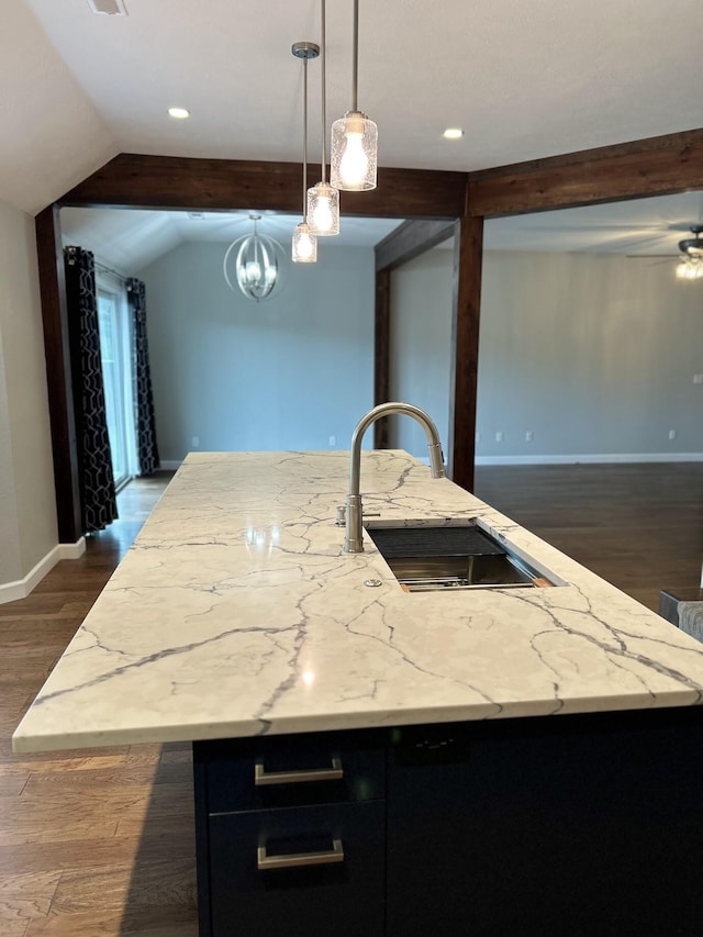 201 Sparrow Ln, Willard, MO 65781 - kitchen with dark cabinetry, a kitchen island with sink, light stone counters, dark wood-style flooring, and hanging light fixtures