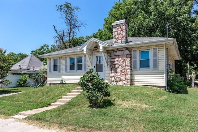 521 W Locust St, Springfield, MO 65803 - view of front of home with a front yard, a chimney, and roof with shingles