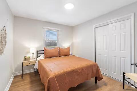 2436 S National Ave, Springfield, MO 65804 - bedroom featuring wood finished floors and a closet