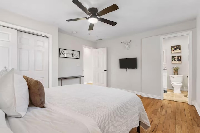 2436 S National Ave, Springfield, MO 65804 - bedroom with a closet, light wood finished floors, a ceiling fan, and connected bathroom