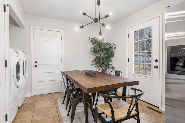 2436 S National Ave, Springfield, MO 65804 - dining area featuring washer and dryer, light tile patterned floors, and a chandelier