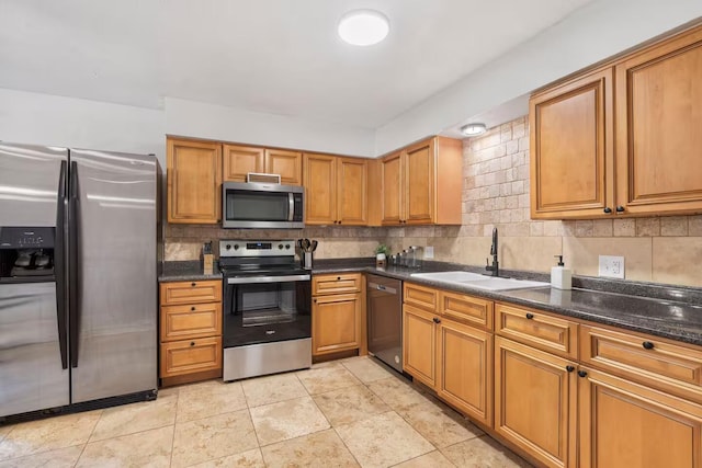2436 S National Ave, Springfield, MO 65804 - kitchen with stainless steel appliances, brown cabinets, and tasteful backsplash