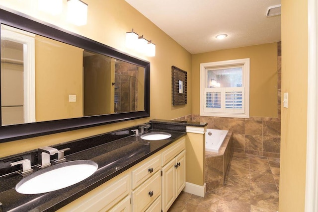 147 River Bluff Dr, Branson, MO 65616 - bathroom with a garden tub and double vanity