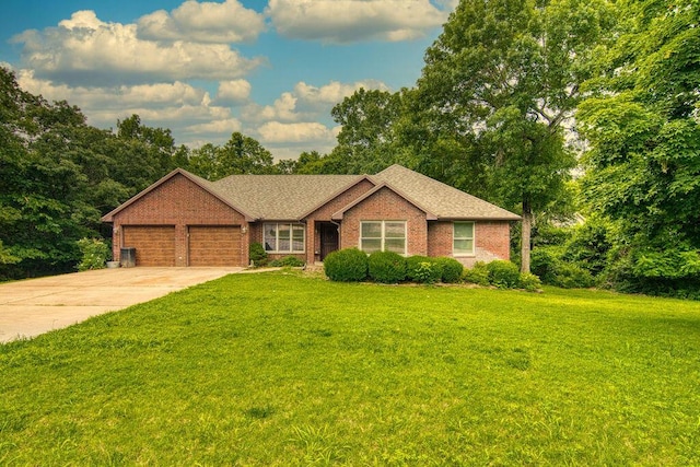 147 River Bluff Dr, Branson, MO 65616 - ranch-style house with brick siding, an attached garage, a front yard, and driveway