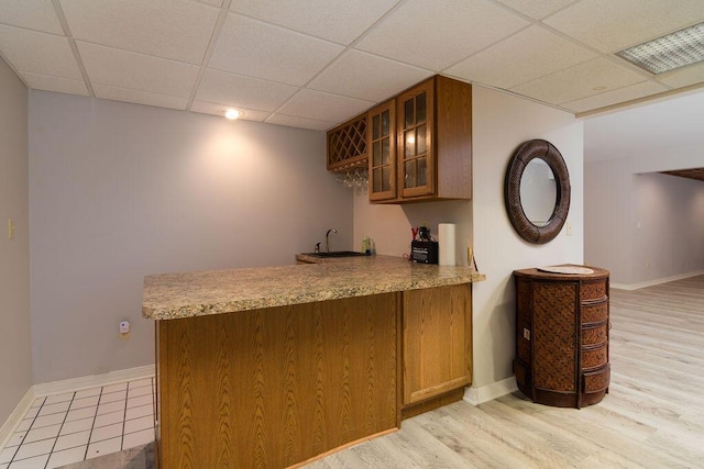 147 River Bluff Dr, Branson, MO 65616 - indoor wet bar featuring a drop ceiling and light wood-style flooring