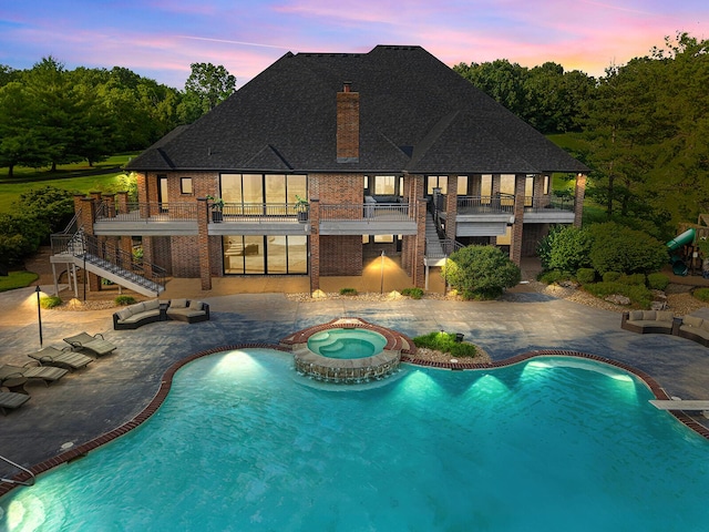 621 S Woodhaven Rd, Nixa, MO 65714 - pool at dusk featuring stairs, a patio, and a pool with connected hot tub