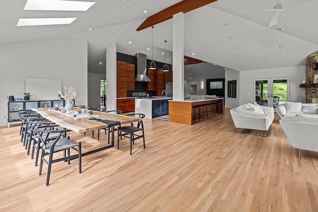 621 S Woodhaven Rd, Nixa, MO 65714 - dining area featuring high vaulted ceiling, light wood-style flooring, a skylight, a ceiling fan, and beamed ceiling