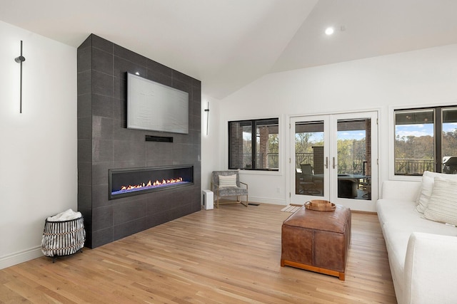 621 S Woodhaven Rd, Nixa, MO 65714 - living room with a tile fireplace, light wood finished floors, french doors, high vaulted ceiling, and recessed lighting