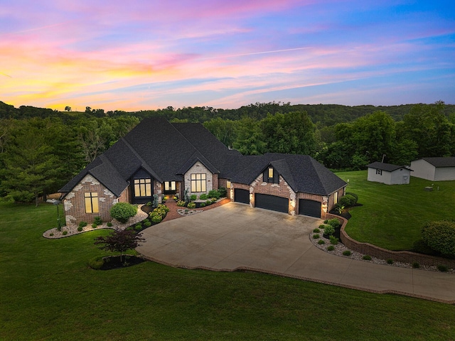 621 S Woodhaven Rd, Nixa, MO 65714 - french country inspired facade featuring an attached garage, stone siding, a front lawn, driveway, and a view of trees