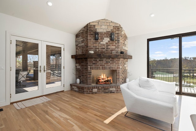 621 S Woodhaven Rd, Nixa, MO 65714 - living room featuring vaulted ceiling, plenty of natural light, french doors, wood finished floors, and recessed lighting