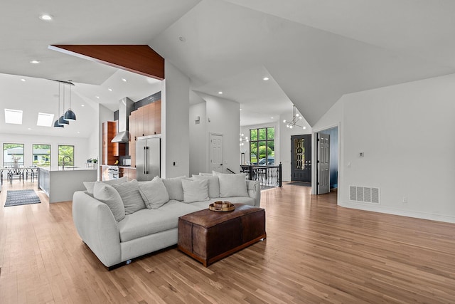 621 S Woodhaven Rd, Nixa, MO 65714 - living area featuring high vaulted ceiling, light wood-type flooring, a chandelier, and recessed lighting