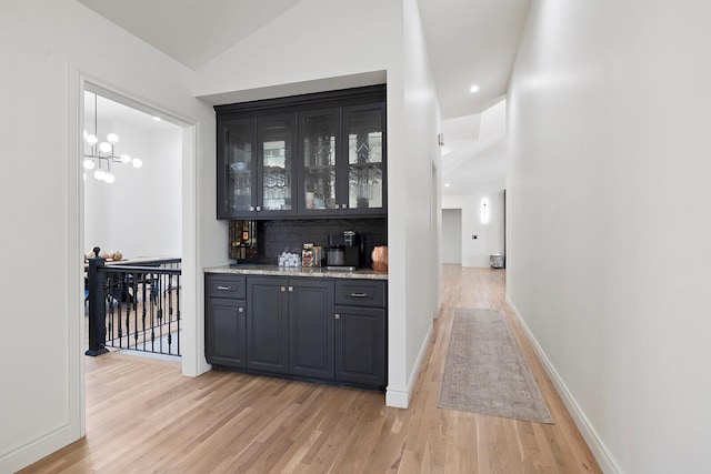 621 S Woodhaven Rd, Nixa, MO 65714 - indoor bar featuring light wood-style floors, vaulted ceiling, decorative backsplash, and recessed lighting