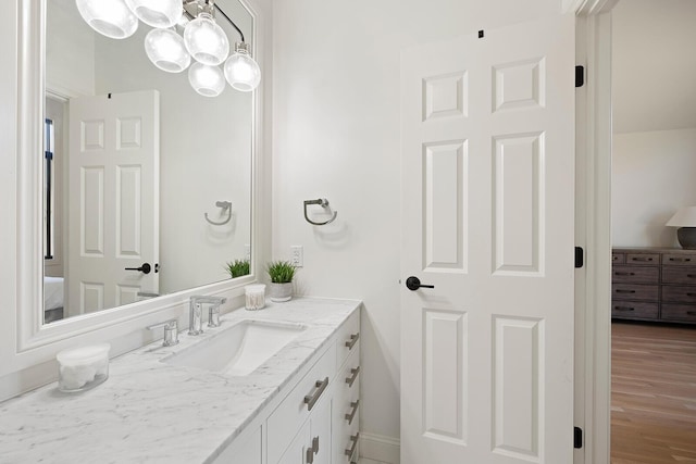 621 S Woodhaven Rd, Nixa, MO 65714 - bathroom with connected bathroom, vanity, and wood finished floors