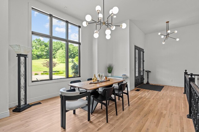621 S Woodhaven Rd, Nixa, MO 65714 - dining area featuring a chandelier, light wood-style flooring, french doors, and a high ceiling