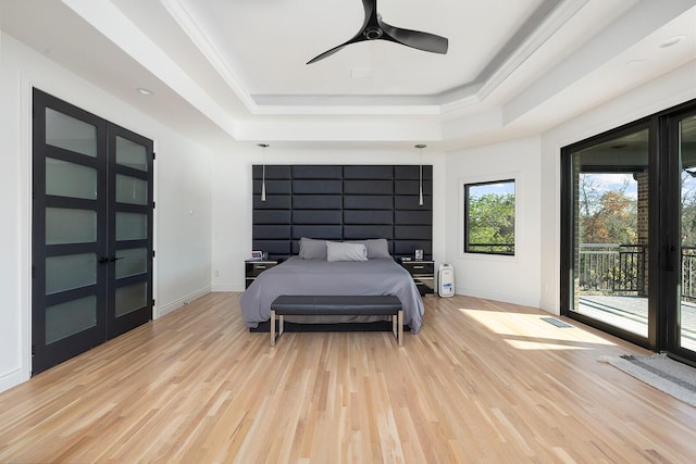 621 S Woodhaven Rd, Nixa, MO 65714 - bedroom featuring a raised ceiling, light wood finished floors, access to exterior, and ceiling fan