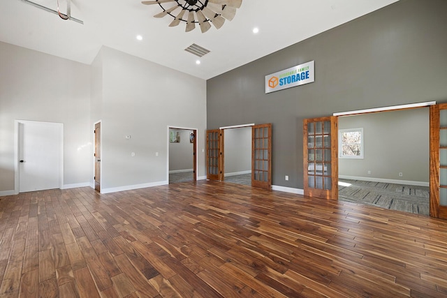 621 S Woodhaven Rd, Nixa, MO 65714 - unfurnished living room with a towering ceiling, french doors, wood finished floors, and recessed lighting