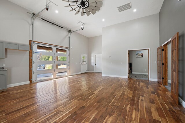 621 S Woodhaven Rd, Nixa, MO 65714 - unfurnished living room with a high ceiling, wood finished floors, and track lighting