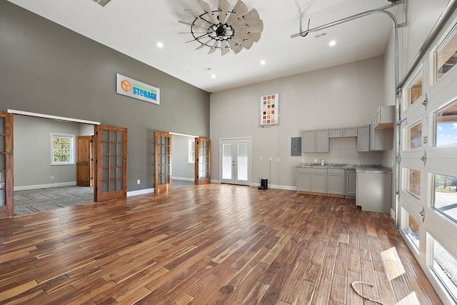 621 S Woodhaven Rd, Nixa, MO 65714 - unfurnished living room with a high ceiling, french doors, wood finished floors, recessed lighting, and electric panel