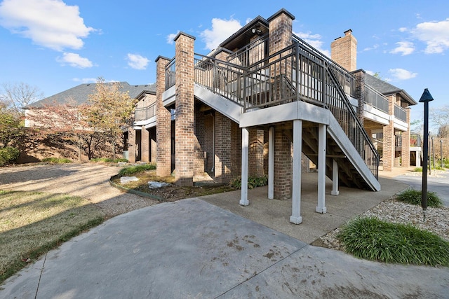 621 S Woodhaven Rd, Nixa, MO 65714 - view of home's exterior with a patio area, a wooden deck, and stairs