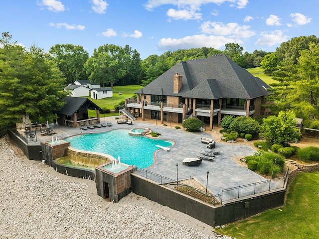 621 S Woodhaven Rd, Nixa, MO 65714 - view of swimming pool featuring an outbuilding, a patio, a pool with connected hot tub, view of wooded area, and stairs
