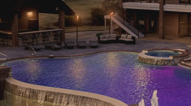 621 S Woodhaven Rd, Nixa, MO 65714 - pool at twilight with a patio, a pool with connected hot tub, stairway, and an outdoor living space
