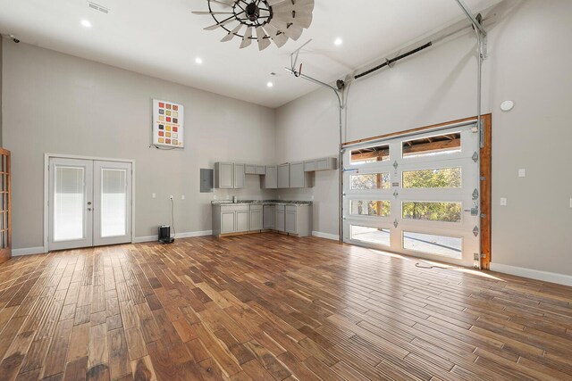621 S Woodhaven Rd, Nixa, MO 65714 - unfurnished living room featuring a towering ceiling, french doors, wood finished floors, recessed lighting, and electric panel