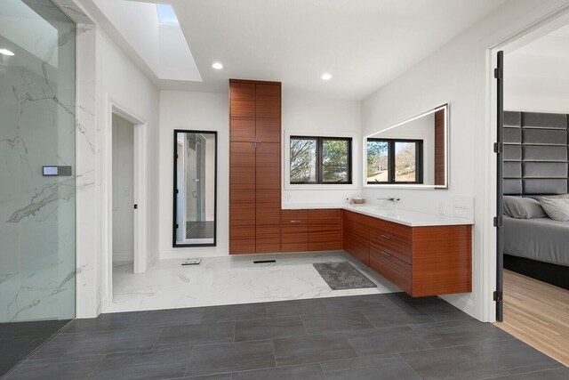 621 S Woodhaven Rd, Nixa, MO 65714 - ensuite bathroom with recessed lighting, vanity, marble finish flooring, and a skylight