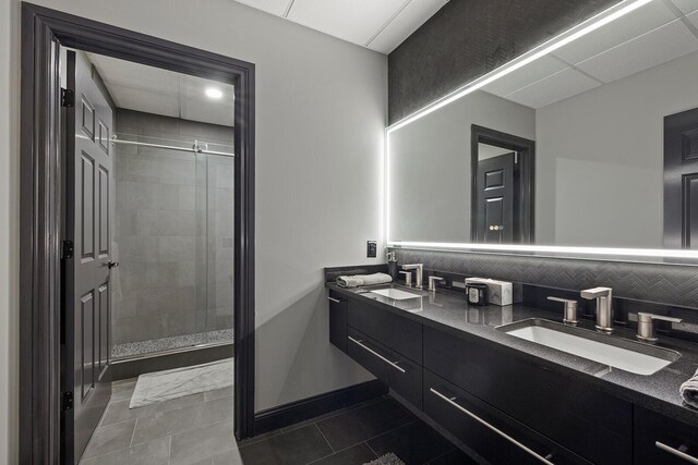 621 S Woodhaven Rd, Nixa, MO 65714 - bathroom featuring double vanity, a stall shower, tile patterned flooring, and tasteful backsplash