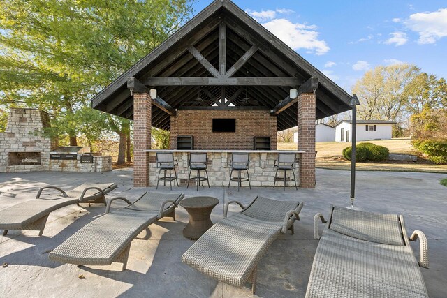 621 S Woodhaven Rd, Nixa, MO 65714 - view of patio / terrace featuring an outdoor bar, a gazebo, and an outdoor kitchen