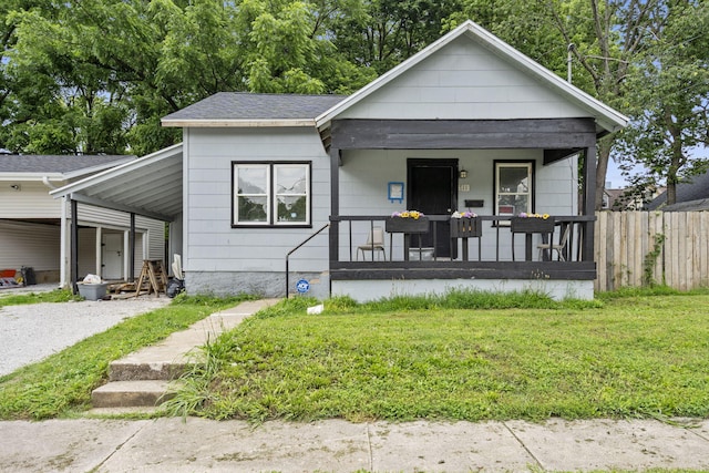 711 W Hovey St, Springfield, MO 65802 - view of front of property featuring a porch, gravel driveway, an attached carport, and a shingled roof