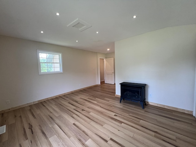2191 County Road 2790, Mountain View, MO 65548 - spare room with a wood stove, light wood-type flooring, recessed lighting, and attic access