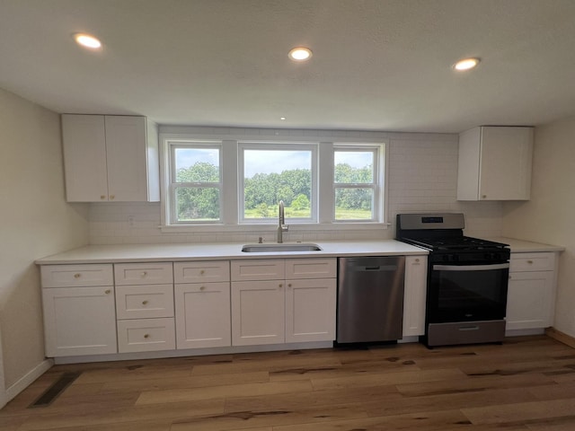 2191 County Road 2790, Mountain View, MO 65548 - kitchen featuring appliances with stainless steel finishes, decorative backsplash, white cabinetry, and recessed lighting