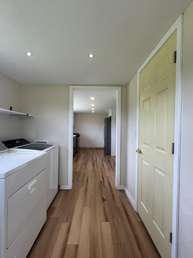 2191 County Road 2790, Mountain View, MO 65548 - laundry room with washing machine and dryer, light wood-style flooring, a textured ceiling, and recessed lighting