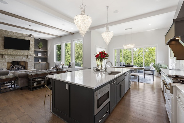5817 E Summit View Dr, Springfield, MO 65809 - kitchen featuring appliances with stainless steel finishes, a chandelier, light countertops, open floor plan, and dark wood finished floors