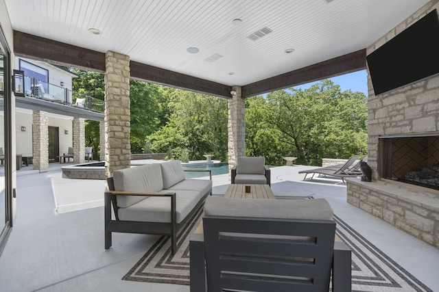 5817 E Summit View Dr, Springfield, MO 65809 - view of patio with an outdoor living space with a fireplace, an outdoor pool, and view of scattered trees