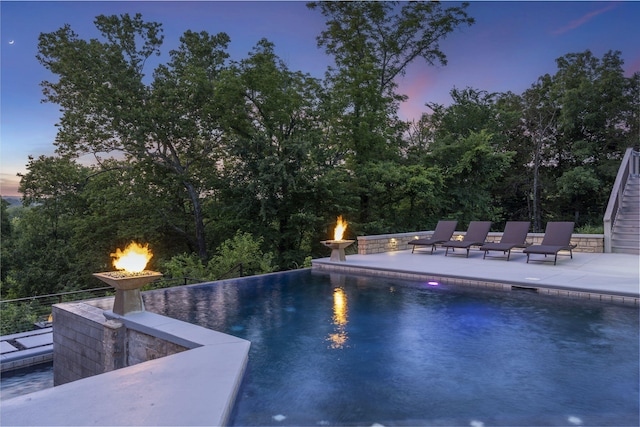 5817 E Summit View Dr, Springfield, MO 65809 - view of swimming pool featuring a patio area, an infinity pool, and an outdoor fire pit