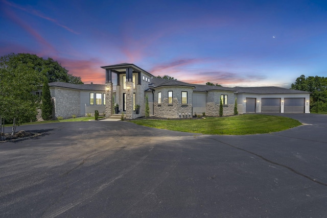 5817 E Summit View Dr, Springfield, MO 65809 - view of front of property featuring stone siding, asphalt driveway, a front yard, and an attached garage