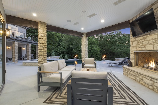 5817 E Summit View Dr, Springfield, MO 65809 - view of patio / terrace with an outdoor living space with a fireplace and view of scattered trees