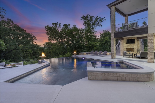 5817 E Summit View Dr, Springfield, MO 65809 - view of swimming pool with an outdoor stone fireplace, a patio area, and a pool with connected hot tub