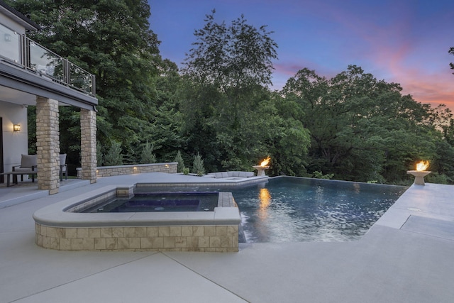 5817 E Summit View Dr, Springfield, MO 65809 - pool at dusk featuring an in-ground hot tub, an outdoor pool, and a patio area