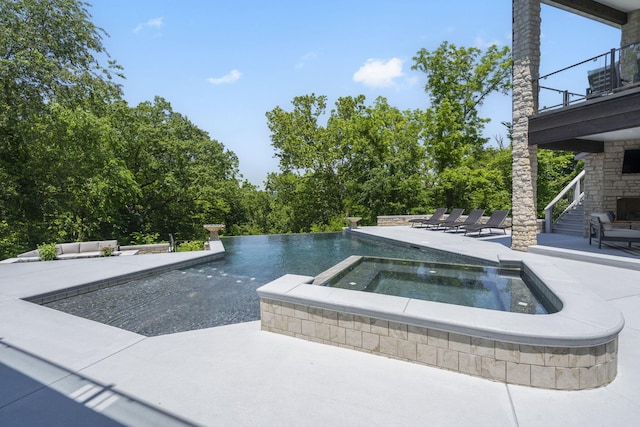 5817 E Summit View Dr, Springfield, MO 65809 - view of pool with a patio area, view of wooded area, and a pool with connected hot tub