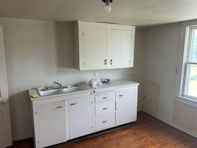 201 W Pennington Ave, Ava, MO 65608 - kitchen with light countertops, dark wood finished floors, white cabinetry, and healthy amount of natural light