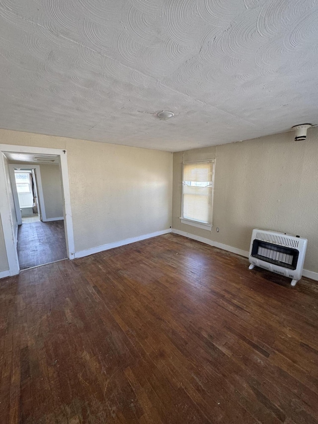 201 W Pennington Ave, Ava, MO 65608 - unfurnished living room featuring heating unit, hardwood / wood-style floors, and a textured ceiling