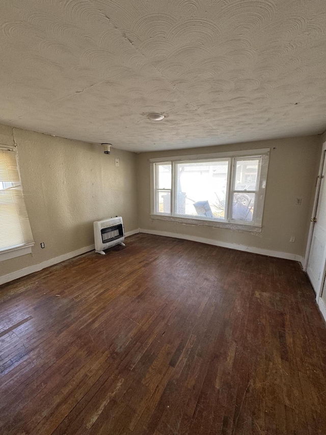 201 W Pennington Ave, Ava, MO 65608 - unfurnished living room with heating unit, a textured ceiling, and dark wood-type flooring
