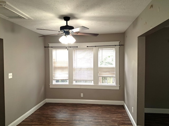 2412 W Olive St, Springfield, MO 65802 - unfurnished room with a textured ceiling, ceiling fan, dark wood-style floors, and plenty of natural light